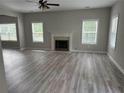 Inviting living room with a fireplace, large windows, and new flooring at 4805 Madison Point Cir, Austell, GA 30106