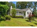 Quaint home with a cozy front porch, beautiful landscaping, and green lawn at 12 Ranger Se Rd, Cartersville, GA 30121