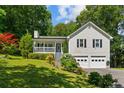 Charming home features a two-car garage, covered front porch, and lush landscaping at 12 Ranger Se Rd, Cartersville, GA 30121