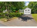 View of the home with landscaped lawn, driveway, and mature trees at 12 Ranger Se Rd, Cartersville, GA 30121