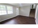 Inviting living room featuring hardwood floors, staircase, and lots of light at 1328 Hoy Taylor Dr, Norcross, GA 30093