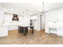 Modern kitchen features white cabinets, stainless appliances, and island at 2113 Ella Springs Dr, Covington, GA 30014