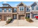 Charming townhome with stone accents, well-maintained landscaping, and attached garages at 2309 Rolling Trl, Lithonia, GA 30058