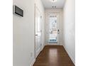 Bright entryway with hardwood floors, white walls, and a view of the front door at 2309 Rolling Trl, Lithonia, GA 30058