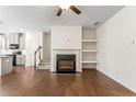 Open-concept living room featuring a fireplace, hardwood floors, and neutral decor at 2309 Rolling Trl, Lithonia, GA 30058
