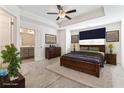 Spacious main bedroom with a tray ceiling, ceiling fan, carpet flooring, and ensuite bathroom at 2309 Rolling Trl, Lithonia, GA 30058