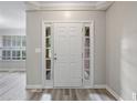 Bright foyer with a white front door, side windows, and light gray walls, leading into the home at 1027 Regency Dr, Acworth, GA 30102