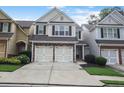 Charming townhouse with brick accents, attached two-car garage, and well-maintained landscaping at 1067 Brownstone Dr # 23, Marietta, GA 30008