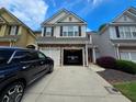 Charming townhome with a one-car garage and a modern gray facade, complemented by a well-kept lawn at 1067 Brownstone Dr # 23, Marietta, GA 30008