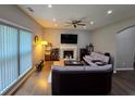 Cozy living room featuring hardwood floors, a fireplace, and a ceiling fan for relaxed living at 1067 Brownstone Dr # 23, Marietta, GA 30008