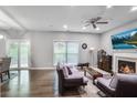 Bright living room featuring hardwood floors, a fireplace, and a large TV at 1067 Brownstone Dr # 23, Marietta, GA 30008