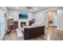 Cozy living room with hardwood floors, a fireplace, and a large TV at 1067 Brownstone Dr # 23, Marietta, GA 30008