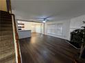 Spacious living room with hardwood floors, fireplace, and open layout leading to the kitchen and dining area at 3613 Tinsley Sw Way, Atlanta, GA 30331