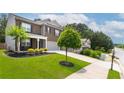 Beautifully landscaped home with a lush green lawn and an extended driveway at 3993 Makeover Ct, South Fulton, GA 30349