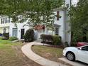 Charming two-story townhome with red awning over the front door and well-maintained landscaping at 1104 Huntington Se Trce, Smyrna, GA 30082