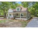 Inviting two-story home with a spacious wrap-around porch and nicely landscaped yard at 159 S Forest S Ave, Social Circle, GA 30025