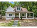 Beautiful two-story home with a welcoming covered porch and well-maintained landscaping at 159 S Forest S Ave, Social Circle, GA 30025