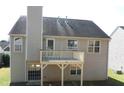 View of a house back exterior with a deck, chimney, siding, a door and some windows at 2918 Egret Ln, Austell, GA 30106