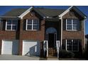 Charming two-story brick home with a two-car garage and manicured front lawn at 2918 Egret Ln, Austell, GA 30106