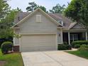 Traditional one-story house featuring a spacious two-car garage, brick accents, and well-maintained landscaping at 2948 Goldfinch Cir, Marietta, GA 30066