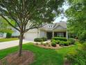 Inviting one-story home with lush green lawn and landscaped bushes surrounded by mature trees at 2948 Goldfinch Cir, Marietta, GA 30066