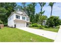 Attractive home with a lush green lawn, long driveway, and an attached two-car garage at 160 Winner St, Acworth, GA 30102