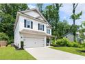 Beautiful two-story home featuring a well-maintained lawn, driveway, and an attached garage at 160 Winner St, Acworth, GA 30102