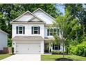 Inviting two-story home with a well-manicured lawn and an attached two-car garage at 160 Winner St, Acworth, GA 30102