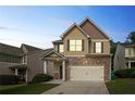 Charming two-story home with stone accents, a two-car garage and manicured lawn at dusk at 5123 Jack Dr, Decatur, GA 30035