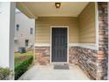 Inviting front porch featuring stone accents and a stylish front door at 5123 Jack Dr, Decatur, GA 30035