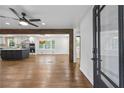 Spacious open-concept living room and kitchen with hardwood floors, modern lighting, and a ceiling fan at 1582 Pine Cir, Austell, GA 30168