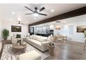 Bright living room featuring hardwood floors, a ceiling fan, and an open concept kitchen and dining area at 1582 Pine Cir, Austell, GA 30168