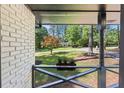 View of the front yard and street from the porch, showcasing the landscaping and the neighborhood setting at 1582 Pine Cir, Austell, GA 30168