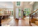 Inviting foyer featuring wood flooring, a staircase, and an open view to the dining area at 1593 Poplarwood Lane Northwest Ln, Lawrenceville, GA 30043