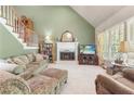 Comfortable living room with a fireplace, neutral carpet, and large windows for natural light at 1593 Poplarwood Lane Northwest Ln, Lawrenceville, GA 30043