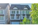 Stately exterior showcases classic architecture with multiple windows that let in ample light and a garage for convenient parking at 2587 Ocean Walk Nw Dr, Atlanta, GA 30318