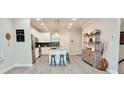 Modern kitchen with stainless steel appliances, an island with bar stools, and sleek countertops offers a stylish cooking space at 2587 Ocean Walk Nw Dr, Atlanta, GA 30318