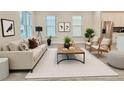 Bright living room featuring stylish furniture, neutral tones, and large windows creates an inviting and sophisticated space at 2587 Ocean Walk Nw Dr, Atlanta, GA 30318