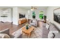 Bright, staged living room with hardwood floors, a ceiling fan, and lots of natural light at 4311 Marci St, Snellville, GA 30039