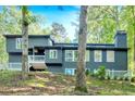 An attractive home with mature trees, bright windows, and a charming white-railed deck at 510 Watergate Ct, Roswell, GA 30076