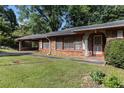A charming single story home with a covered carport and well-manicured lawn at 2386 Springrun Way, Decatur, GA 30032