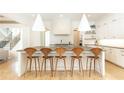 Open kitchen with a large center island, pendant lighting, and seating for five at 3338 Breton Ne Cir, Brookhaven, GA 30319