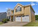 Inviting two-story home featuring a convenient two-car garage and a freshly manicured lawn at 2584 Grayton Loop, Villa Rica, GA 30180