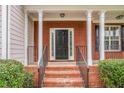Inviting front porch with brick columns and stairs leading to the front door at 2681 Lakeside Sw Dr, Conyers, GA 30094
