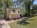 Beautiful exterior showcasing well-maintained lawn and charming stone details at 3924 Chimney Ridge Ct, Ellenwood, GA 30294
