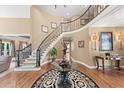 Elegant foyer with a curved staircase, hardwood floors, and sophisticated decor, creating a grand entrance at 162 Daltree Ct, Marietta, GA 30068