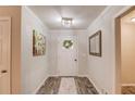 Hallway with hardwood floors, crisp white trim, and neutral walls that provide access to other rooms at 2020 Commonwealth Pl, Cumming, GA 30041