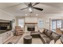 Bright living room featuring a cozy fireplace, hardwood floors, and views of the outdoor entertaining space at 2020 Commonwealth Pl, Cumming, GA 30041