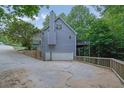 View of the house with a basement garage and an elevated outdoor deck at 402 Wood Chase Ln, Canton, GA 30114