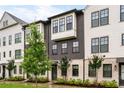 Attractive townhouse exterior features a mix of white and gray materials with complementary black framed windows at 6635 Beacon Dr, Atlanta, GA 30328